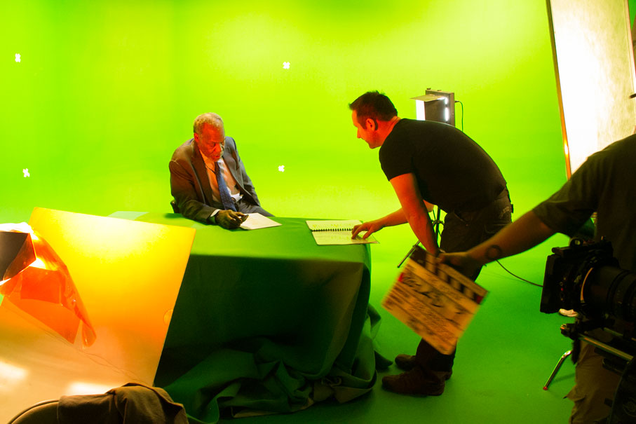Danny Glover seated at a desk during a green-screen feature-film shoot in Los Angeles